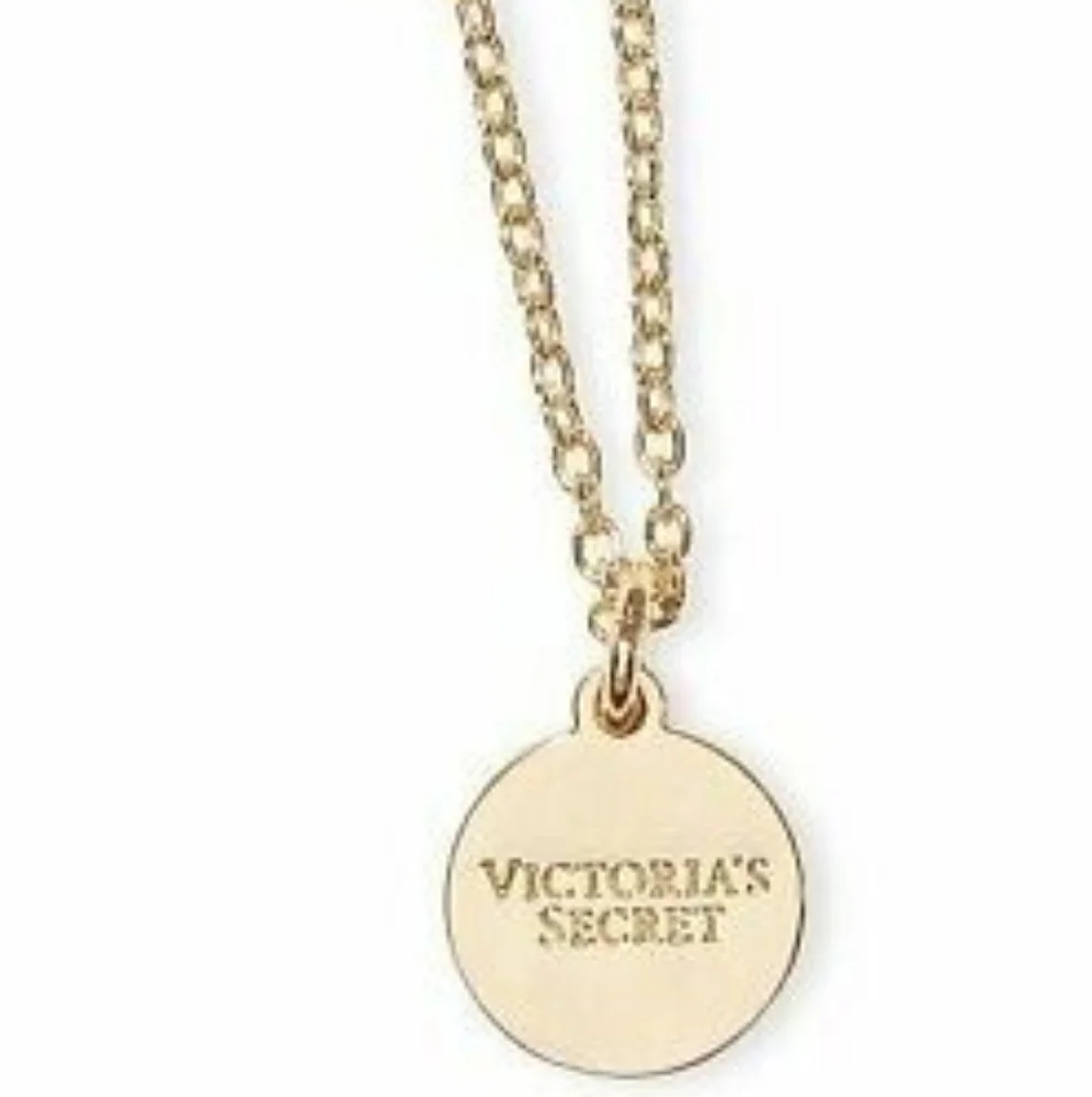 Nip luxury VS v in circle gold tone pendant with chain bottle charm.